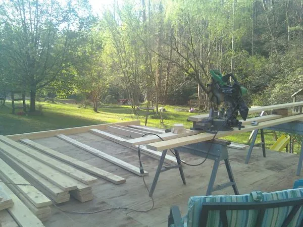 Miter saw and framing lumber on a deck under construction in Mickleton