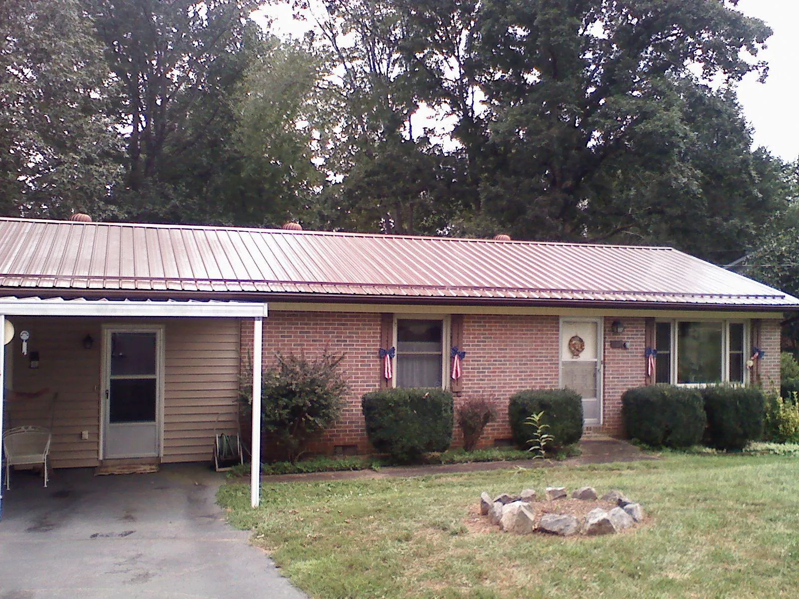 Bronze metal roof and carport on a brick ranch home — Roof Repair work by our crew in Mickleton